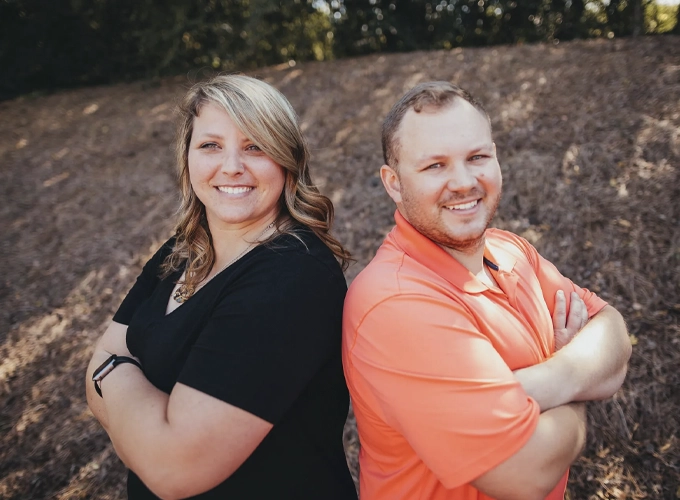 Dr. Kayla Martin D.C. and Dr. Jason Gregory D.C. posing together and smiling.